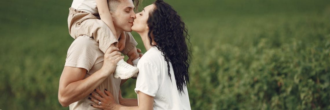 A heartwarming family moment captured in a field, highlighting love and togetherness.
